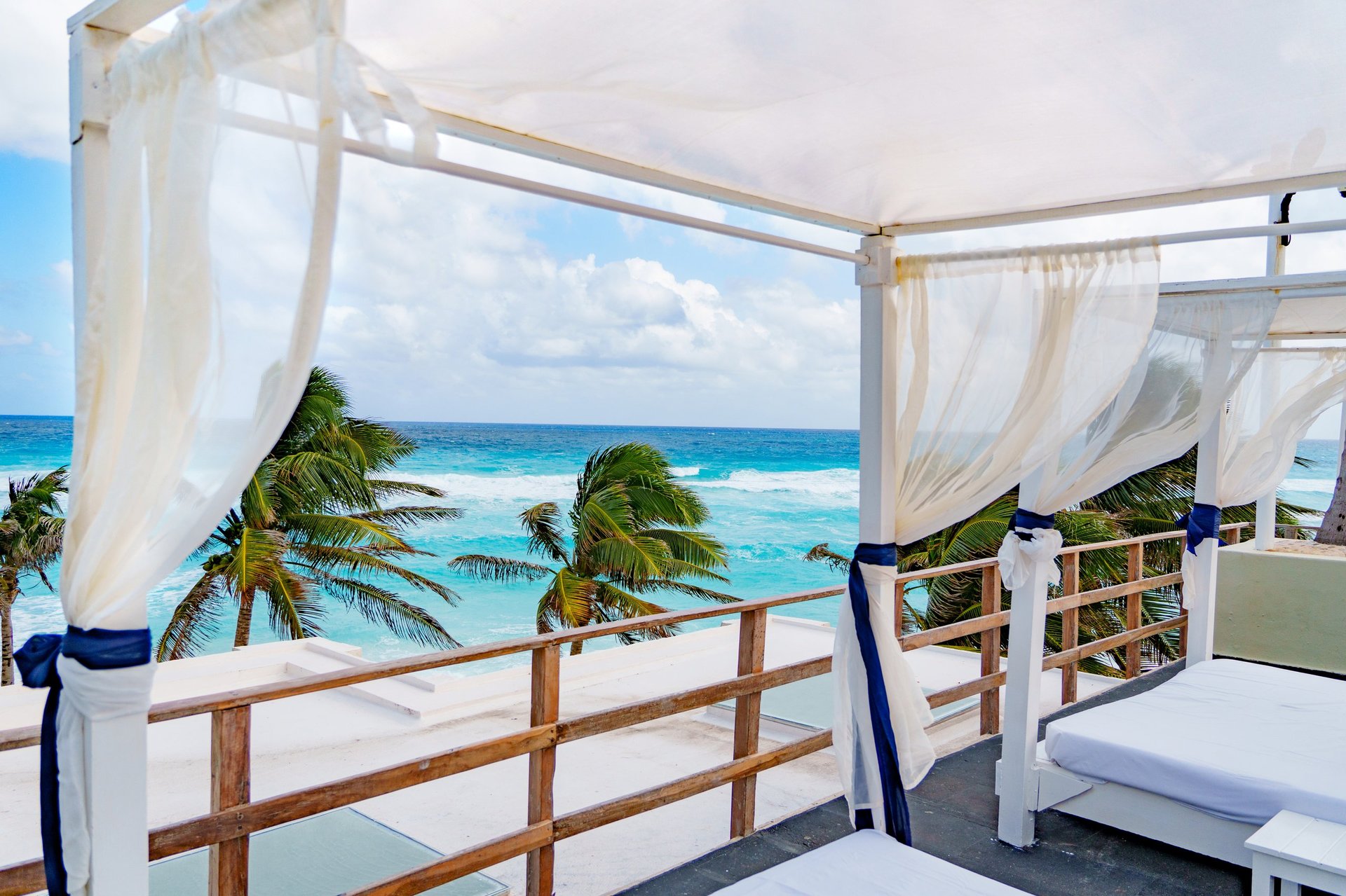 A peaceful rooftop lounge that offers stunning views of the beautiful ocean and swaying palm trees all around