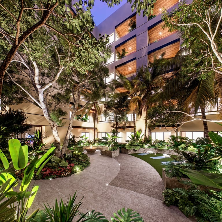 Modern multi-story building with illuminated wooden exterior surrounded by lush tropical landscaping and mature trees in evening light