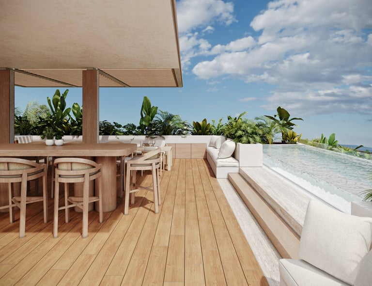 Modern rooftop terrace with wooden deck, seating area, bar stools, white cushioned seating, potted plants, and blue sky view
