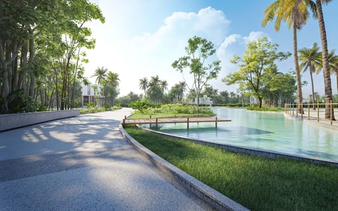 Modern waterfront park with curved pathway, reflecting pond, palm trees, and lush greenery under blue sky