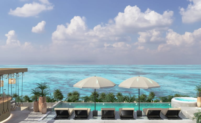 Beachfront resort terrace with loungers, umbrellas, and turquoise ocean view under clear sky