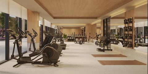 Modern gym interior with cardio equipment, exercise bikes, and workout machines