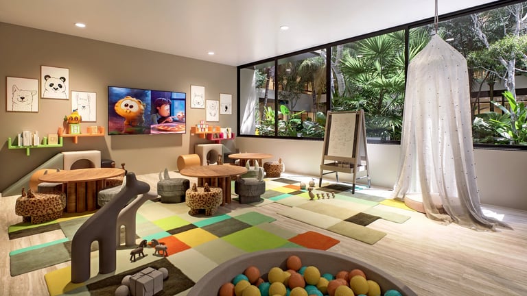 Modern playroom with colorful ball pit, wooden toys, artwork on walls, large windows overlooking garden, and reading nook with canopy