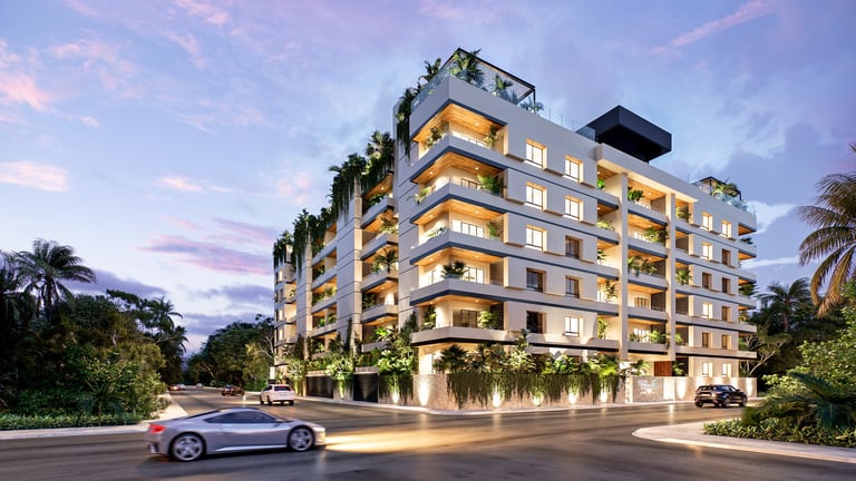 Modern luxury apartment building at dusk with illuminated facades, lush greenery, and a silver car in front