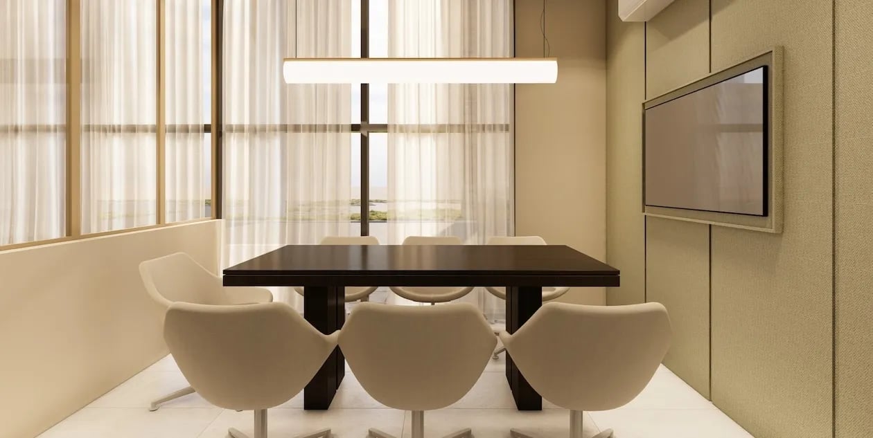 Modern dining room with black table, three cream-colored chairs, and floor-to-ceiling windows with sheer curtains
